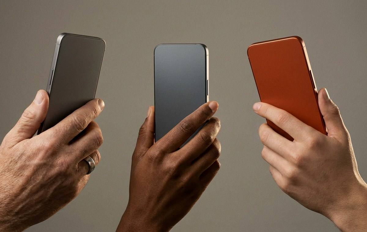 Three people holding compact smartphones in different finishes